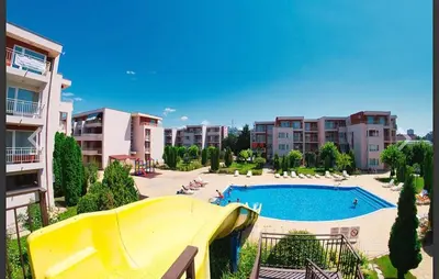a swimming pool with a slide in a resort at Studio near the center in Sunny Beach