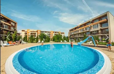 a swimming pool with a slide in a resort at Studio near the center in Sunny Beach