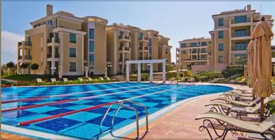 a large swimming pool with chairs and some buildings at Flores Gardan ART Studio in Chernomorets