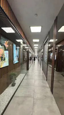 a hallway in a building with people walking down it at Flores Gardan ART Studio in Chernomorets