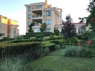 a building with a garden in front of it at Flores Gardan ART Studio in Chernomorets