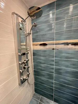 a shower in a bathroom with a glass wall at 2BR Garden Bay Apartment in Varna City