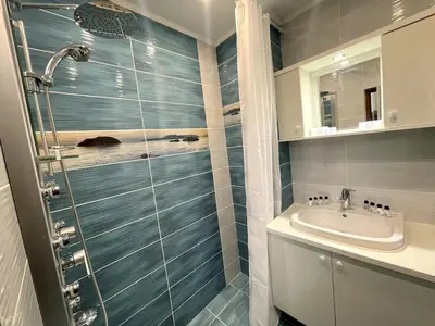 a bathroom with a shower and a sink at 2BR Garden Bay Apartment in Varna City