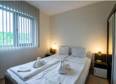 a bedroom with a large white bed with towels on it at The white flat in Byala