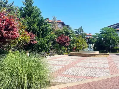 a stone walkway with a fountain in a park at Cozy Ground-Floor Apartment with Terrace in Sozopol