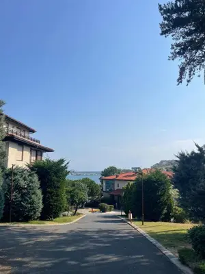 a road with a building and a house on it at Cozy Ground-Floor Apartment with Terrace in Sozopol