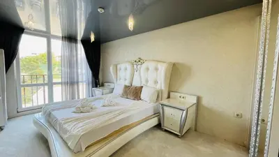 a bedroom with a large white bed with a window at PARADADISO B 307 Two Bedroom Sea View Apartment in Nesebar