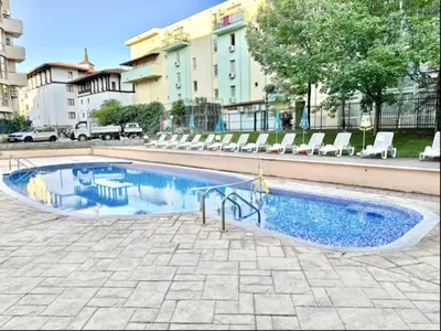 a small swimming pool with chairs in a building at Sunny Sea - Menada Apartments in Sunny Beach