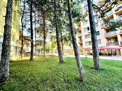 a group of trees in front of a building at Sunny Sea - Menada Apartments in Sunny Beach
