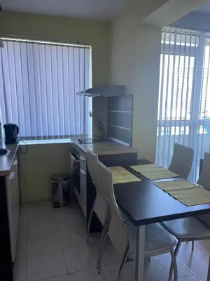 a kitchen with a table and chairs in a room at 2-bedroom Apartment in Marina Holiday Club Pomorie in Pomorie