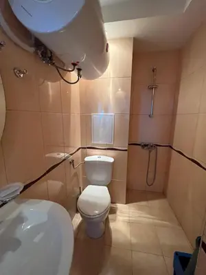 a bathroom with a toilet and a sink and a shower at 2-bedroom Apartment in Marina Holiday Club Pomorie in Pomorie