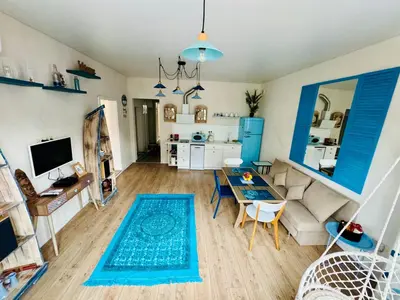 a living room with a blue rug on the floor at ap Knyaz Boris I in Varna City