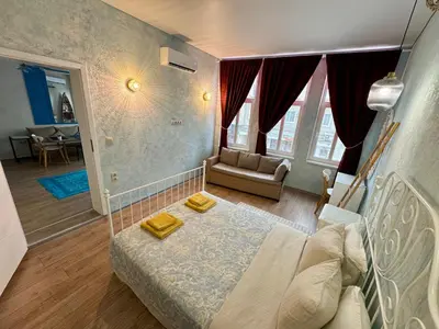 a living room with a bed and a couch at ap Knyaz Boris I in Varna City