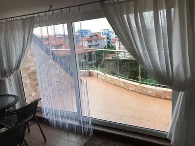 a view of a balcony from a window with curtains at Terasa Ravda apart in Ravda