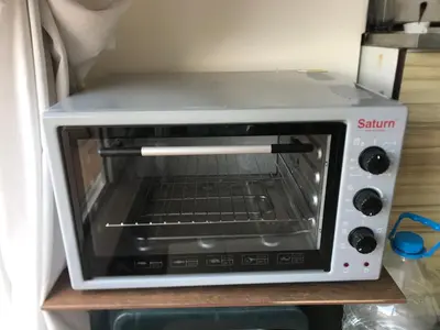 a toaster oven sitting on a shelf in a refrigerator at Terasa Ravda apart in Ravda