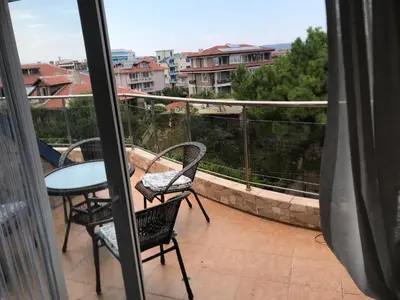 a balcony with a table and chairs and a view at Terasa Ravda apart in Ravda
