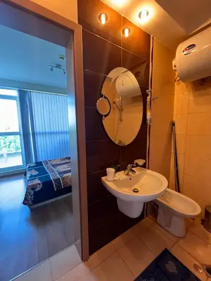 a bathroom with a sink and a mirror at Private 2-Bedroom Apartment with Pool and Free Parking in Marina Holiday Club Pomorie in Pomorie