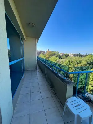 a balcony with a bench and a view of the city at Private 2-Bedroom Apartment with Pool and Free Parking in Marina Holiday Club Pomorie in Pomorie