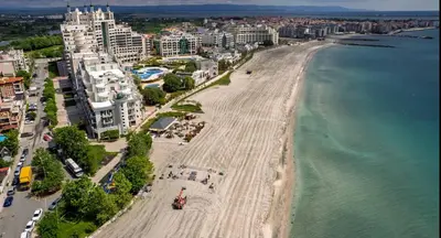an aerial view of a beach with buildings and the ocean at Private 2-Bedroom Apartment with Pool and Free Parking in Marina Holiday Club Pomorie in Pomorie