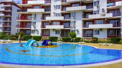 a swimming pool in front of a apartment building at Two bedroom Apartment in Fort Noks Panorama beach in Elenite