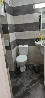 a bathroom with a toilet and a sink at Библиотеката in Pomorie