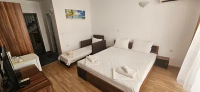 a bedroom with a bed with two towels on it at Библиотеката in Pomorie
