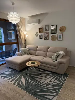 a living room with a couch and a table at Boho apartament Cascadas family in Sunny Beach