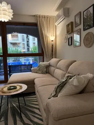 a living room with a couch and a table at Boho apartament Cascadas family in Sunny Beach