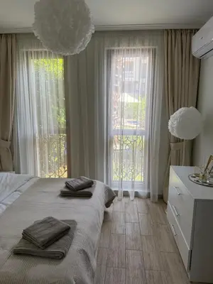 a bedroom with a large bed with towels on it at Boho apartament Cascadas family in Sunny Beach