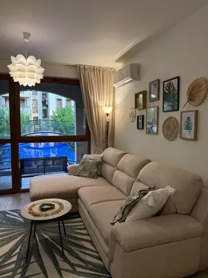 a living room with a couch and a table at Boho apartament Cascadas family in Sunny Beach