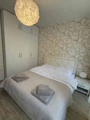 a bedroom with a bed with two towels on it at Boho apartament Cascadas family in Sunny Beach