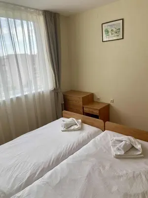 a small bedroom with two beds and a window at Peaceful, Top Floor, 2 Bedroom in Sunny Beach