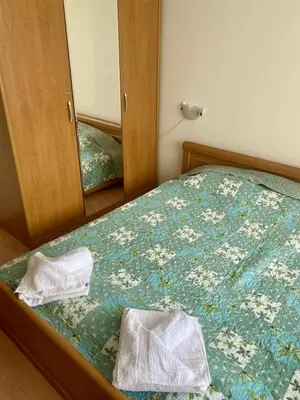 a bedroom with a bed with two towels on it at Peaceful, Top Floor, 2 Bedroom in Sunny Beach