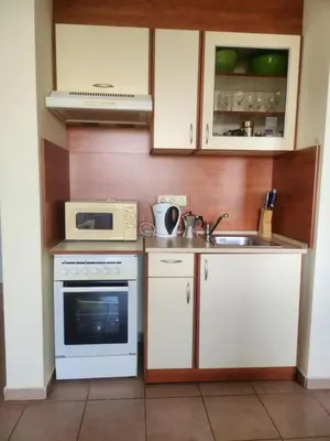 a kitchen with a sink and a microwave at Peaceful, Top Floor, 2 Bedroom in Sunny Beach