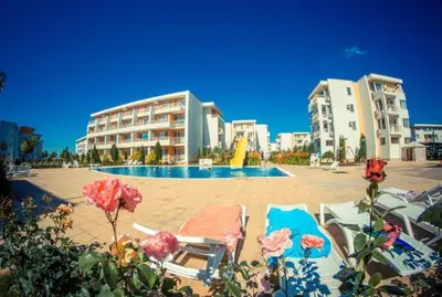a resort with a pool and some chairs and buildings at Peaceful, Top Floor, 2 Bedroom in Sunny Beach