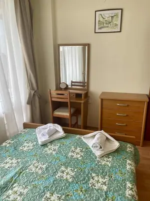 a bedroom with a bed and a dresser and a mirror at Peaceful, Top Floor, 2 Bedroom in Sunny Beach