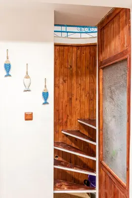 a staircase in a room with wood paneling at Afala Loft & Terrase - Heart of Burgas in Burgas City