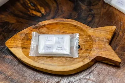 a block of soap on a wooden cutting board at Afala Loft & Terrase - Heart of Burgas in Burgas City