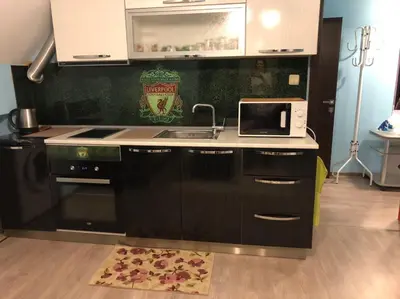 a kitchen with a sink and a microwave at Anfid Apartments in Burgas City