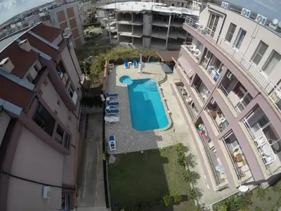 an overhead view of a swimming pool between two buildings at Anfid Apartments in Burgas City