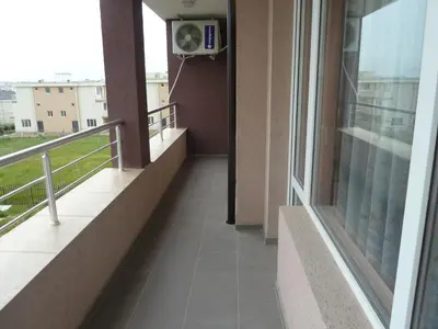a balcony of a building with a fan at Anfid Apartments in Burgas City