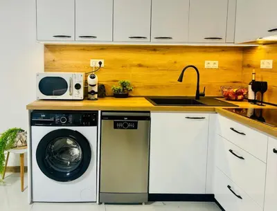 a kitchen with a washing machine and a sink at Sea Breeze in Burgas City