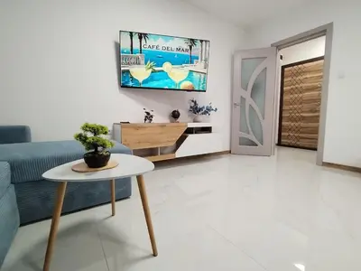 a living room with a couch and a table at Sea Breeze in Burgas City
