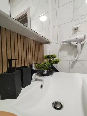 a bathroom with a sink with plants on it at Sea Breeze in Burgas City