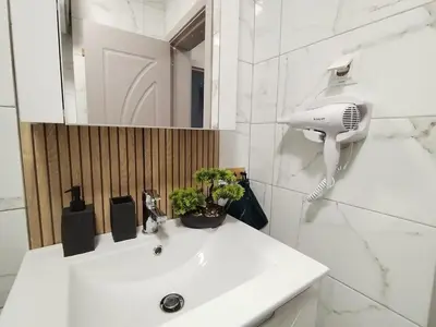 a bathroom with a white sink with a hair dryer at Sea Breeze in Burgas City