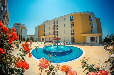 a large swimming pool in front of a building at Imperial Sea View in Burgas City