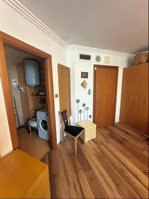 a living room with a table and a chair in a room at Emerald Breeze Studio in Hotel SPA Resort Emerald in Ravda