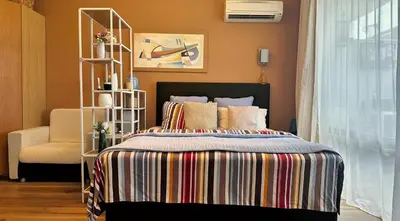 a bedroom with a bed and a chair at Emerald Breeze Studio in Hotel SPA Resort Emerald in Ravda