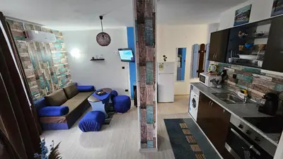 a small living room with a couch and a kitchen at Apartment 16 - Rainbow Holiday Complex in Sunny Beach