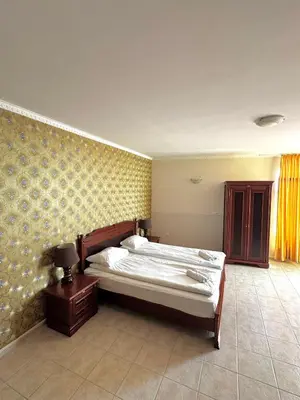 a bedroom with a bed and a table with a nightstand at Sea View Apartment Sveti Vlas in Sveti Vlas